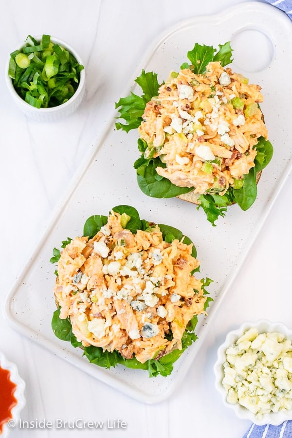 Overhead pictures of lettuce topped with buffalo chicken salad.