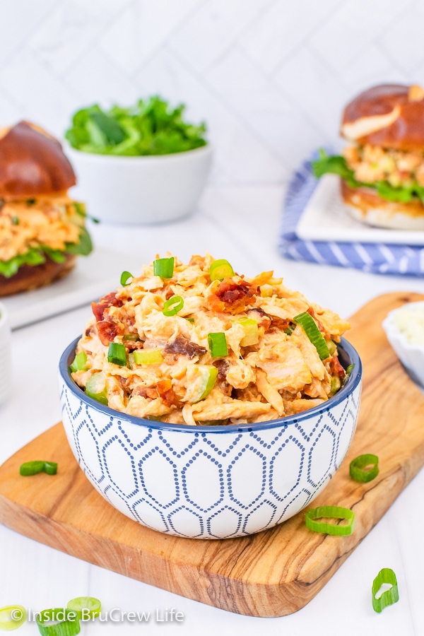 A white and blue bowl filled with spicy chicken salad.