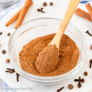 A clear glass bowl filled with a spice blend.