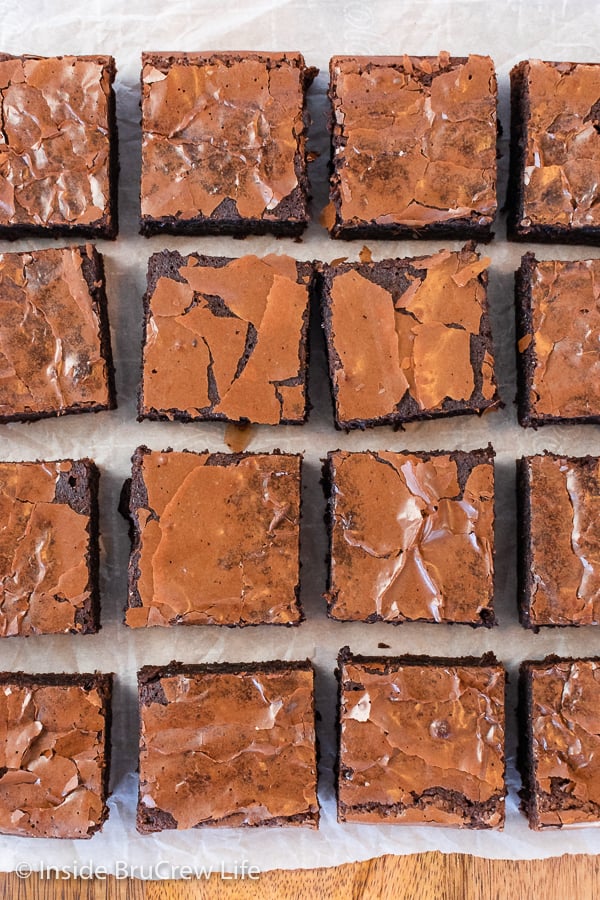 Overhead picture of squares of brownies on a board.