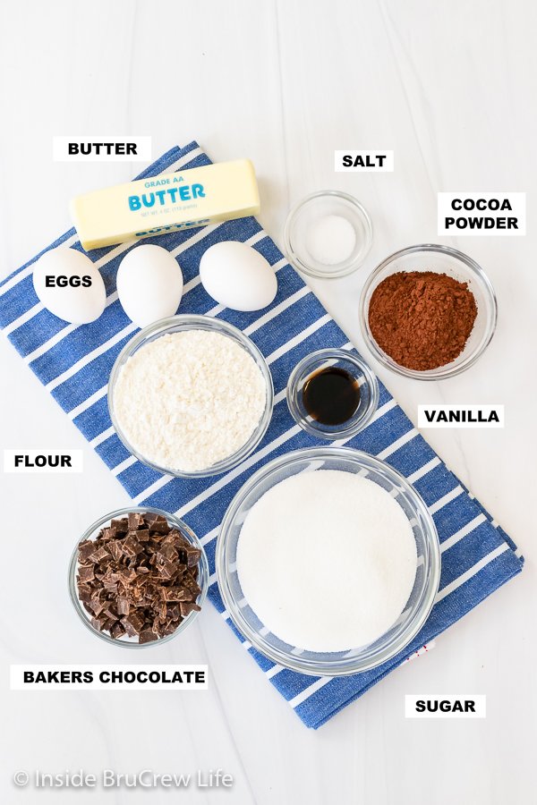 A white board with bowls of ingredients needed to make brownies.