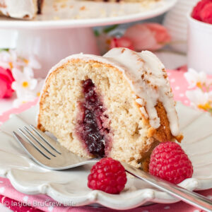 A white cake with a slice of jelly filled cake on it.