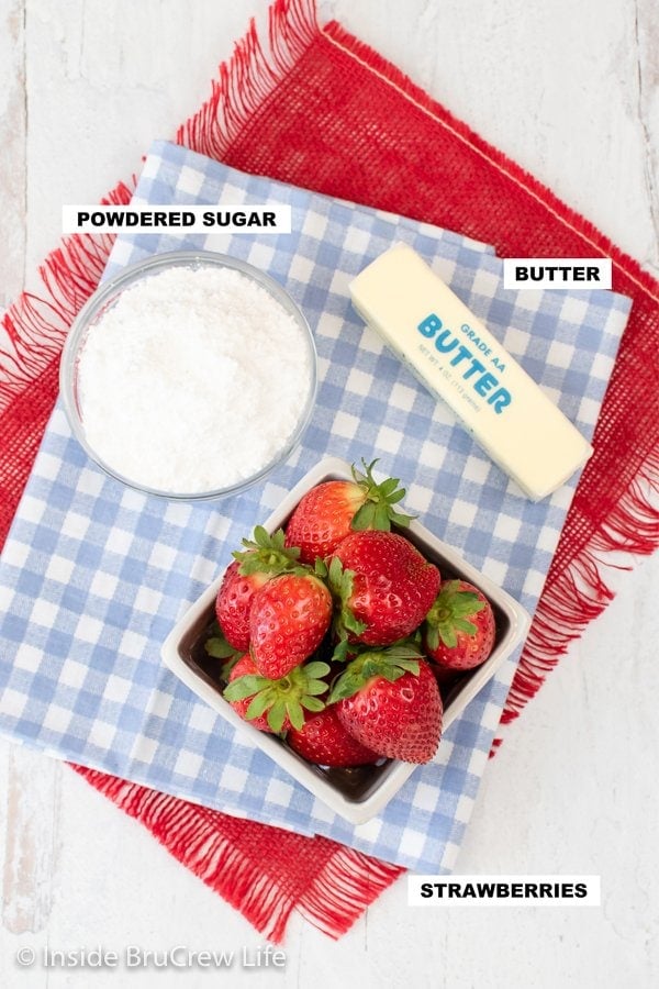 A blue and white towel with the ingredients needed to make a whipped strawberry butter.