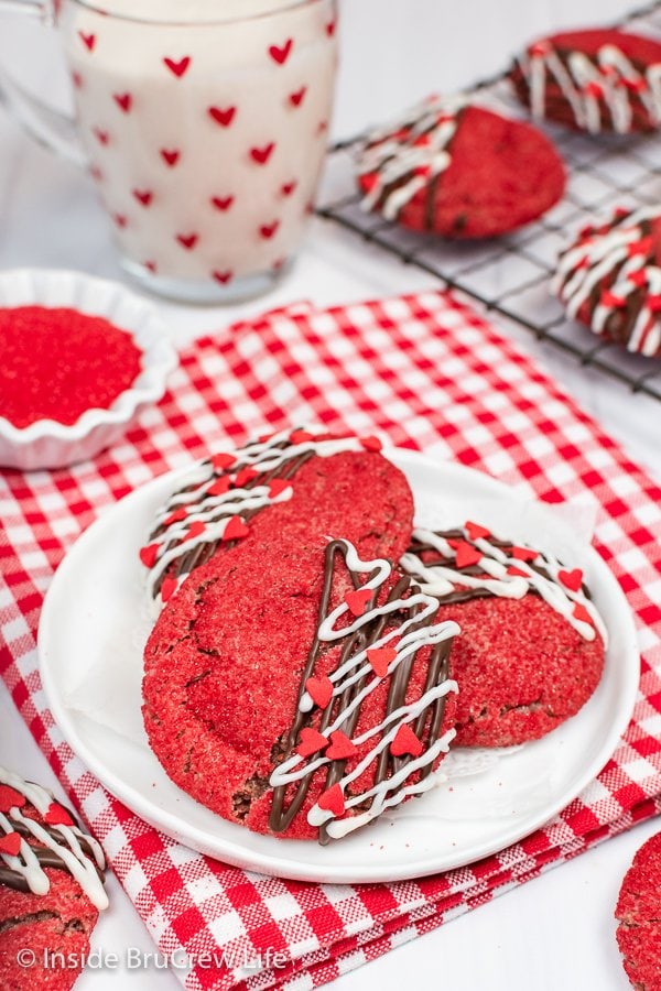 Three red sugar cookies on a white plate.