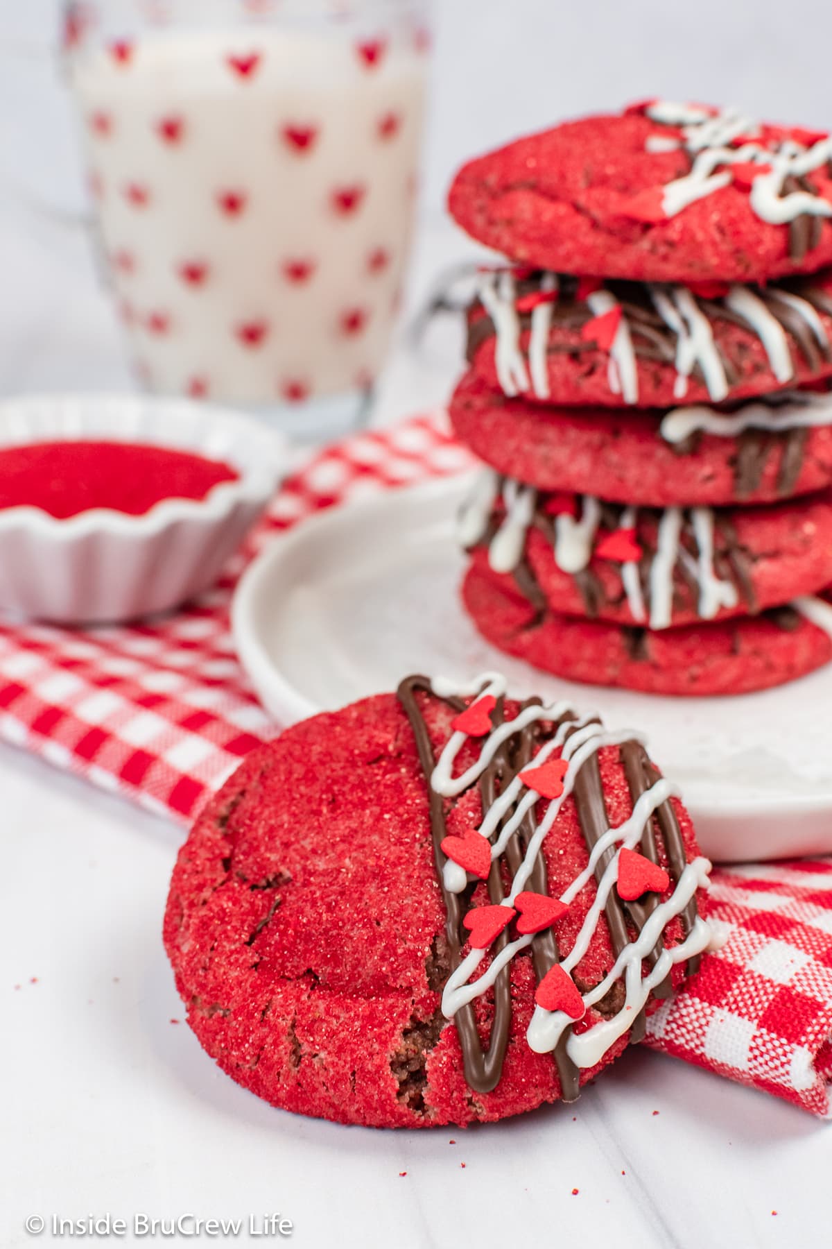 A stack of red sugar cookies with one leaning on the side.