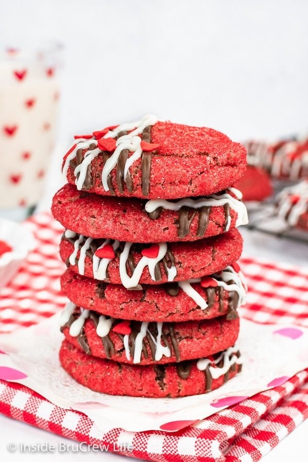 A stack of red sugar cookies on a white paper.