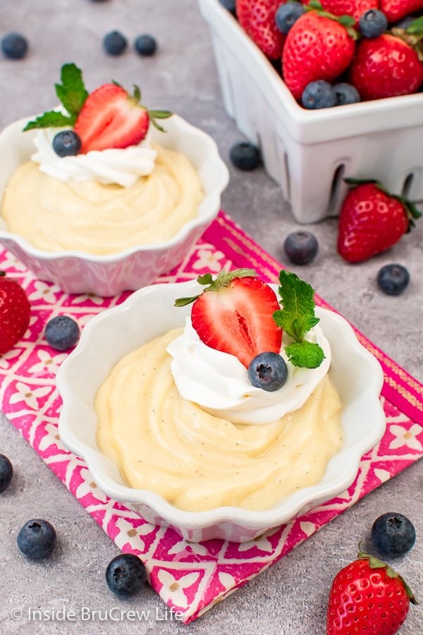 Two white bowls filled with vanilla pudding.