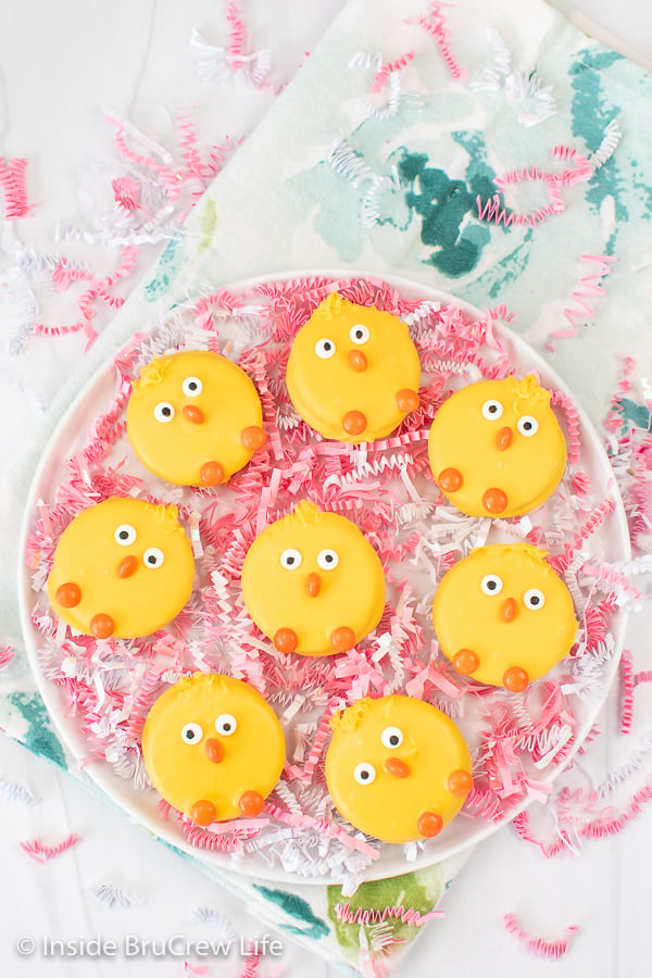 A white plate with yellow Oreo chicks lying on it.