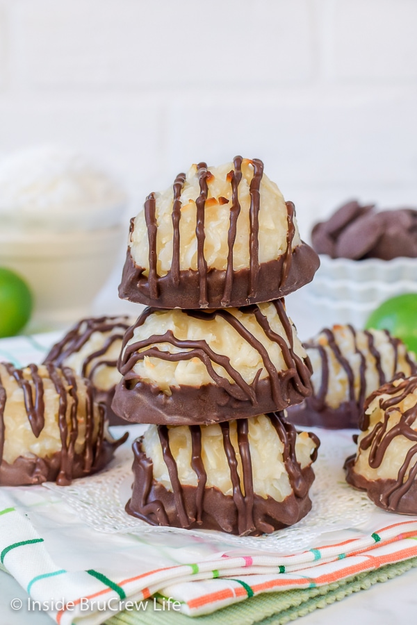 Three coconut macaroons stacked on top of each other on a plate.