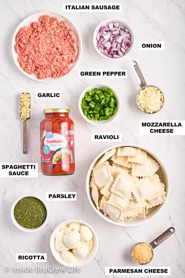 A white board with ingredients needed to make skillet lasagna ravioli on it.
