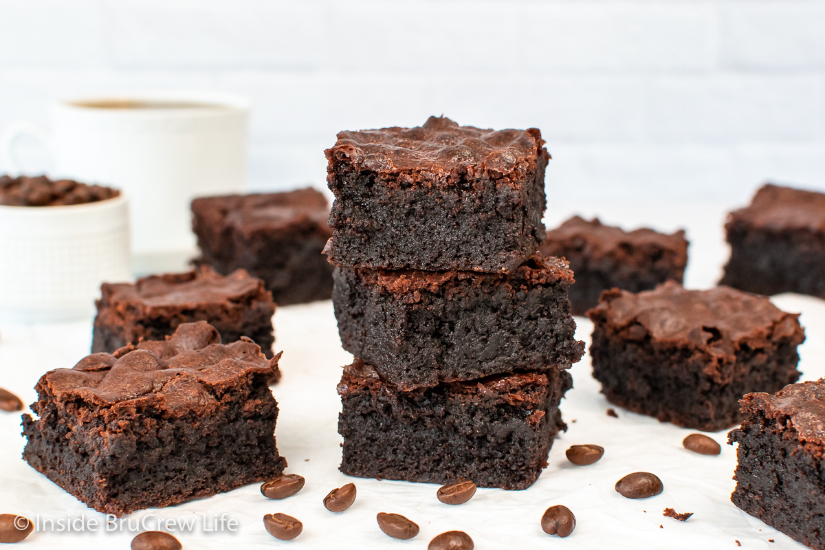 Three coffee brownies stacked together on a white surface.