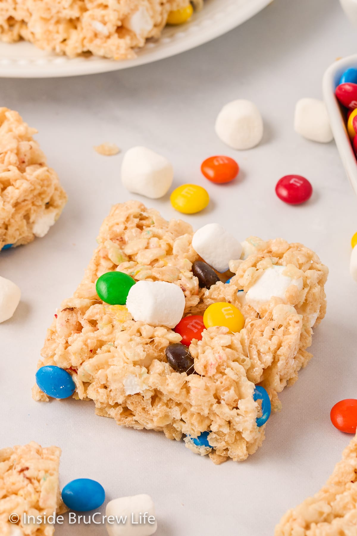 Rice krispie treat squares on a white board.