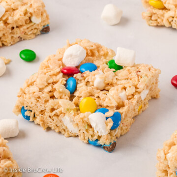 Rice krispie treat squares on a white board.