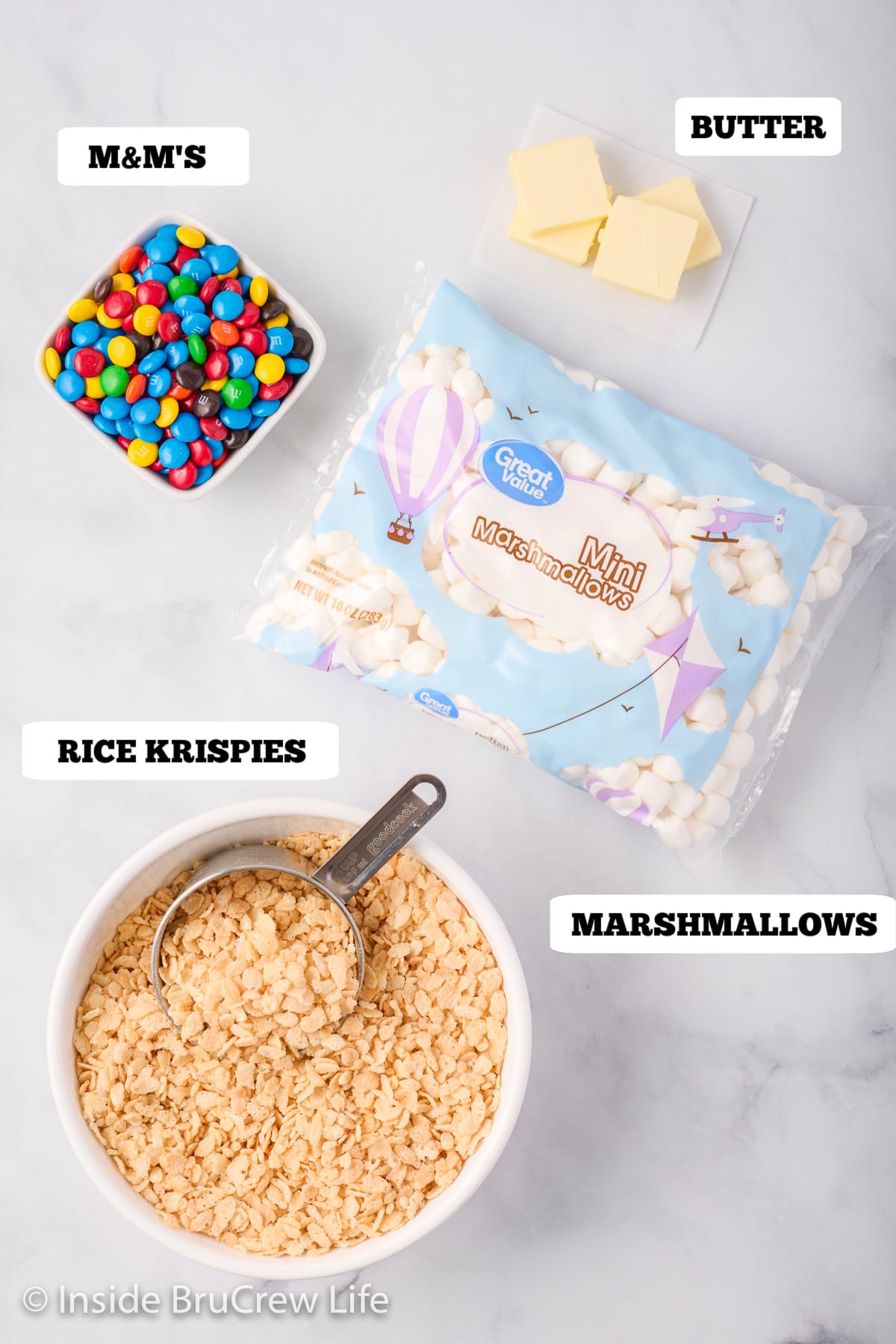 Bowls of ingredients needed to make homemade rice krispie treats.