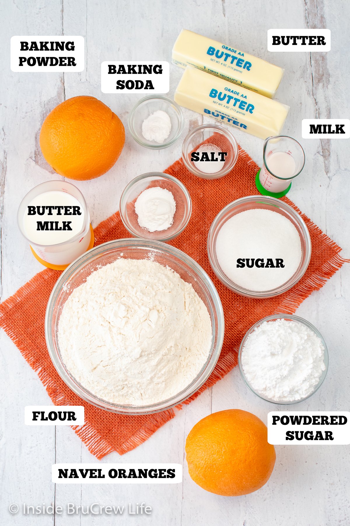 A white board with bowls of ingredients for sweet rolls.