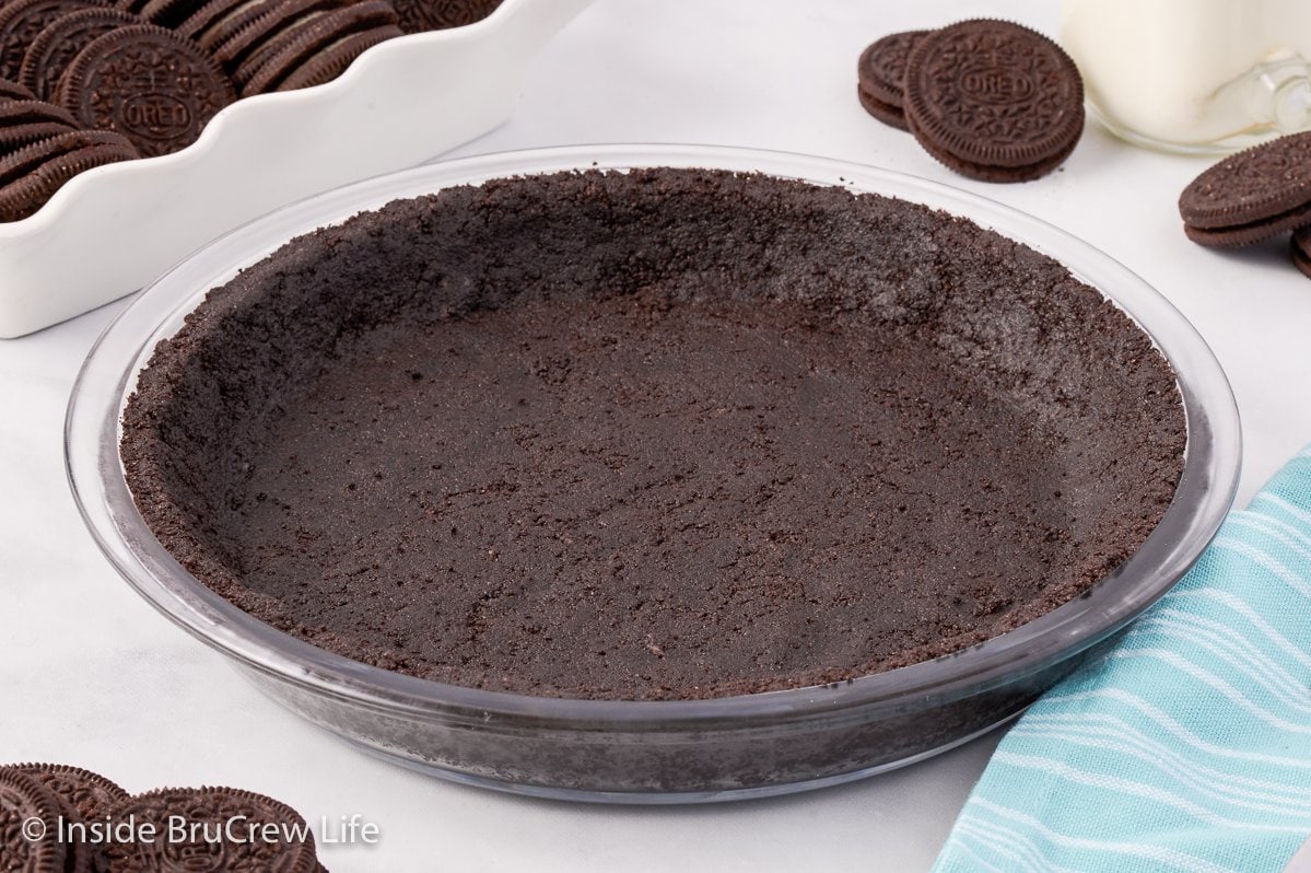 A chocolate cookie crust on a white board.