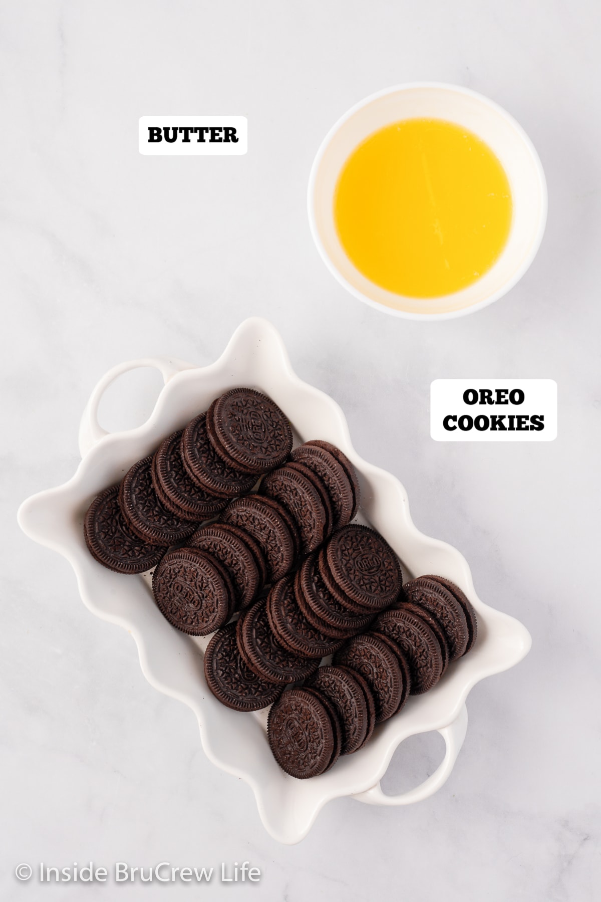 Oreo cookies and melted butter in bowls.