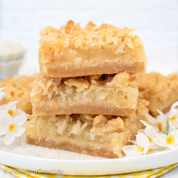 A stack of three pineapple bars on a white plate.