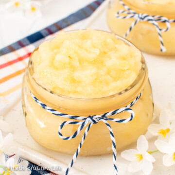 A clear jar filled with pineapple pie filling.
