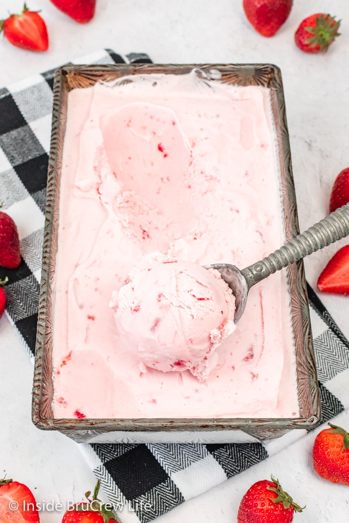 A metal pan filled with strawberry ice cream.