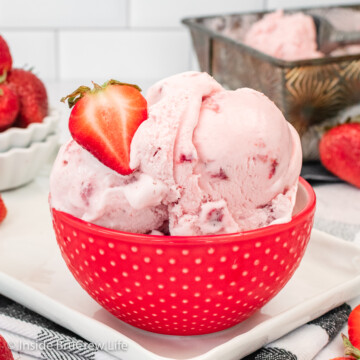 A red bowl with scoops of pink ice cream in it.