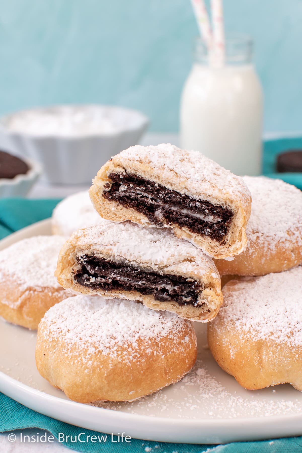 A plate with Oreo biscuits stacked on a plate.