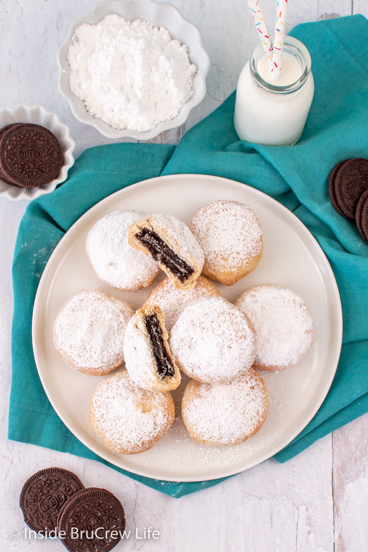 Overhead picture of a plate with powdered sugar biscuits.