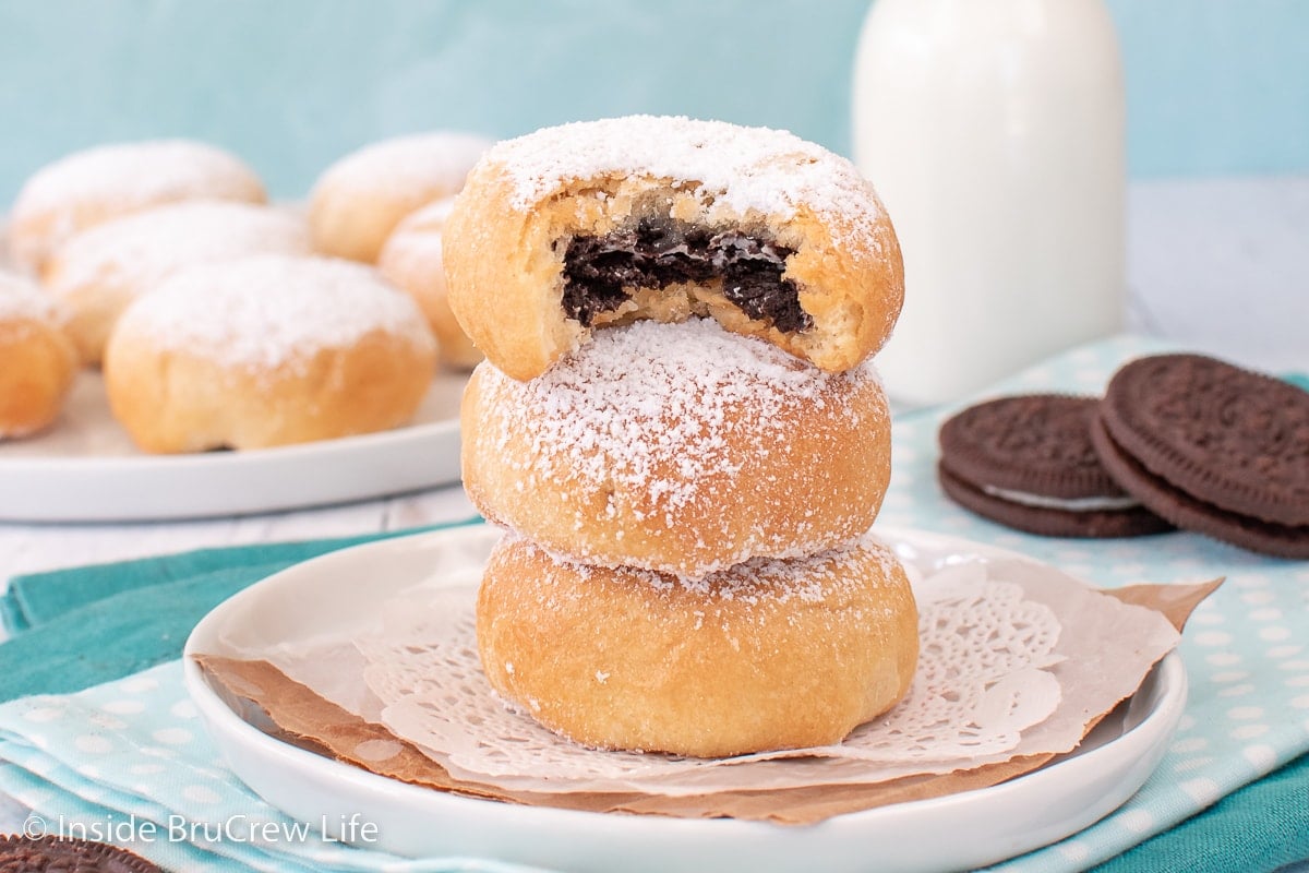 A white plate with three Oreo stuffed biscuits on it.