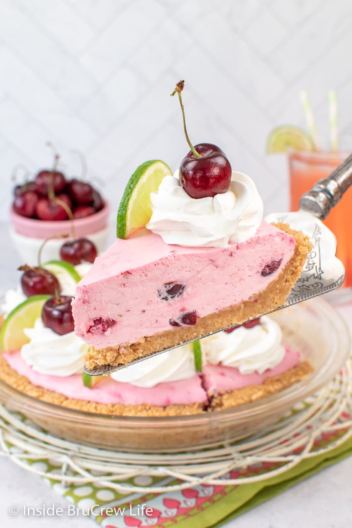 A slice of pink no bake cherry pie on a spatula.