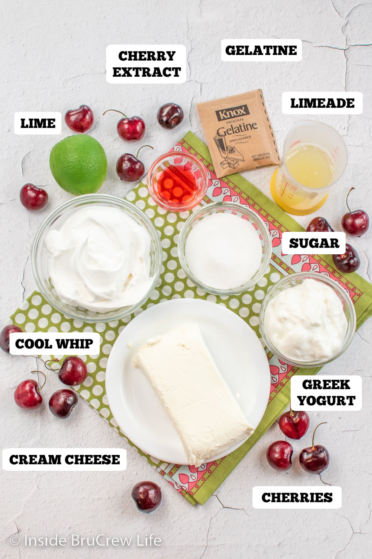 A white board with bows of ingredients to make pink cherry pie.