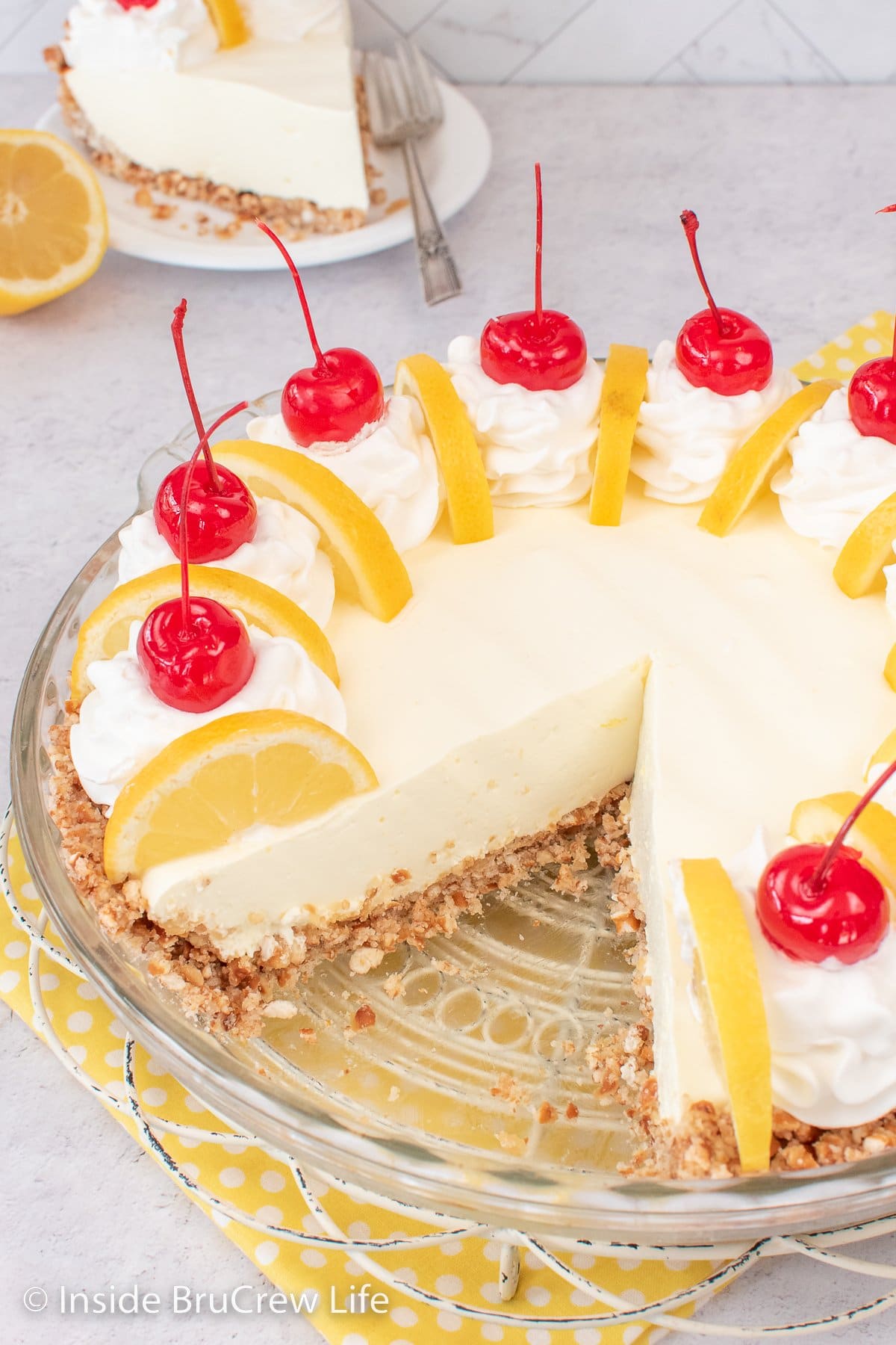 A lemon pie in a glass plate.