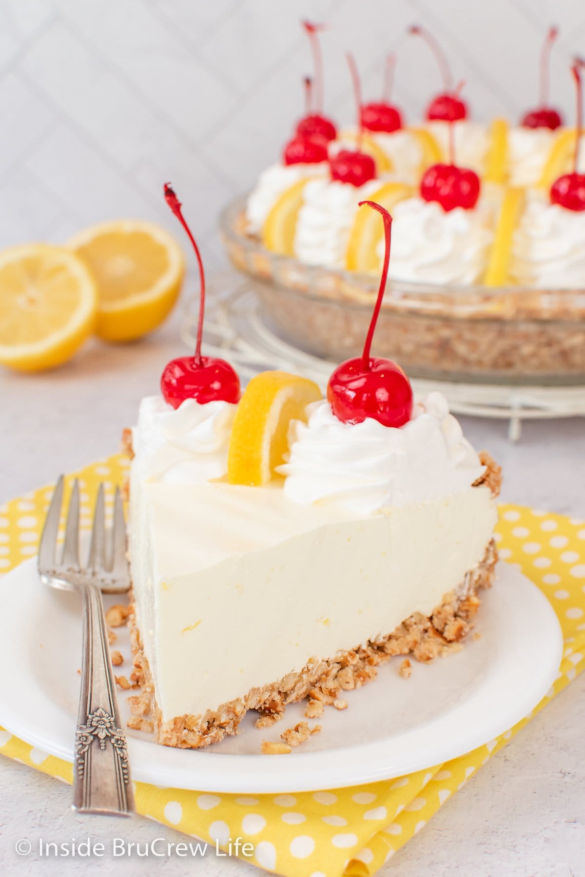 Fluffy lemon pie on a white plate.