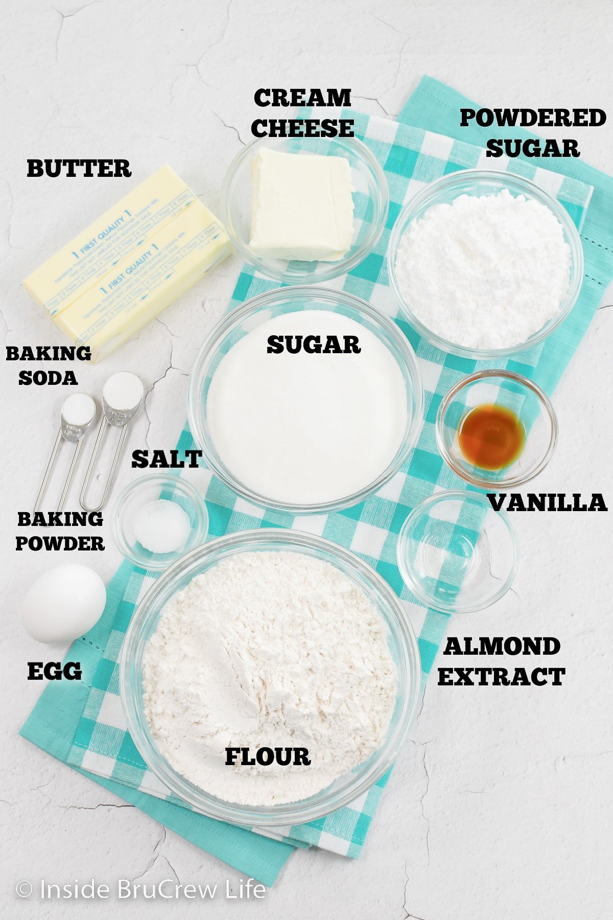 A white board with bowls of ingredients needed to make a dessert pizza.