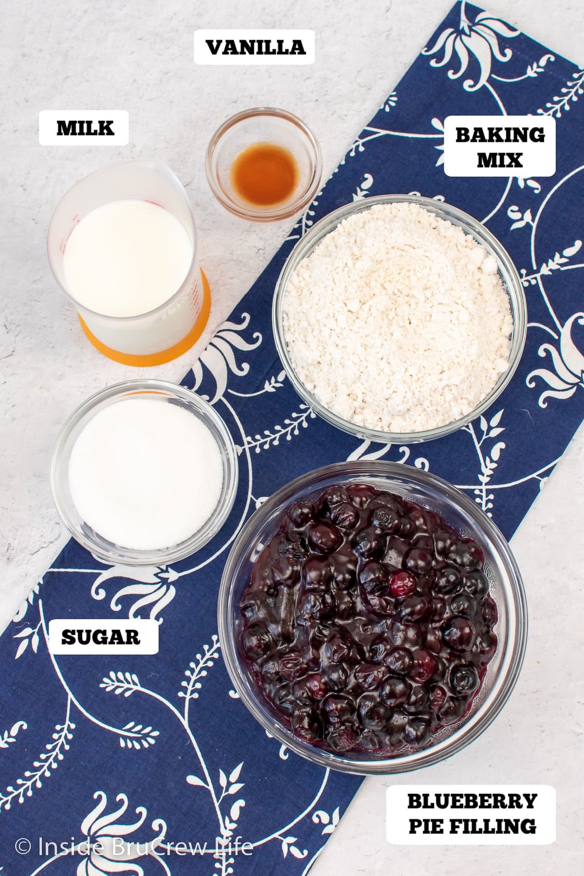 Bowls of ingredients needed to make a fruit dessert.