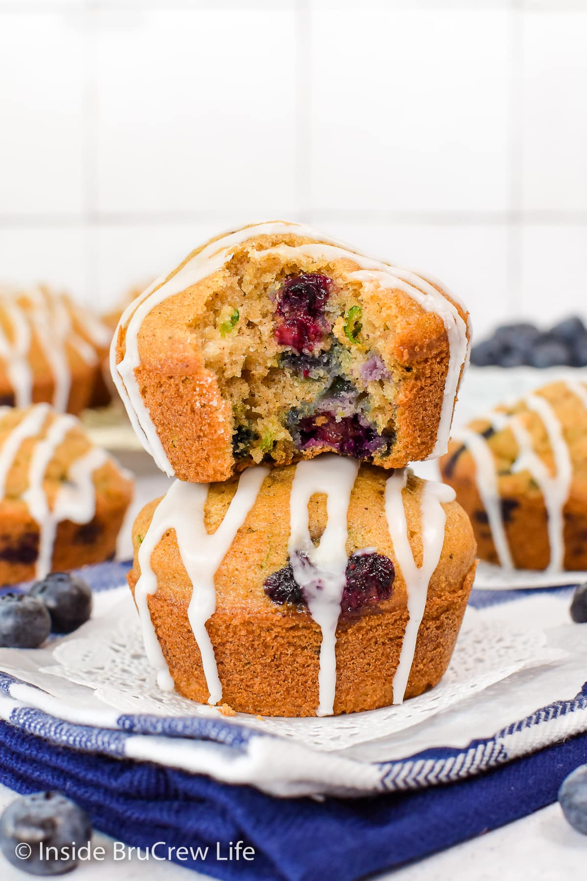 Two zucchini muffins stacked on top of each other.