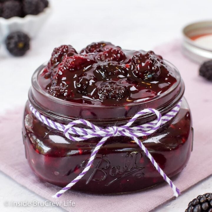 A glass jar filled with homemade blackberry pie filling.