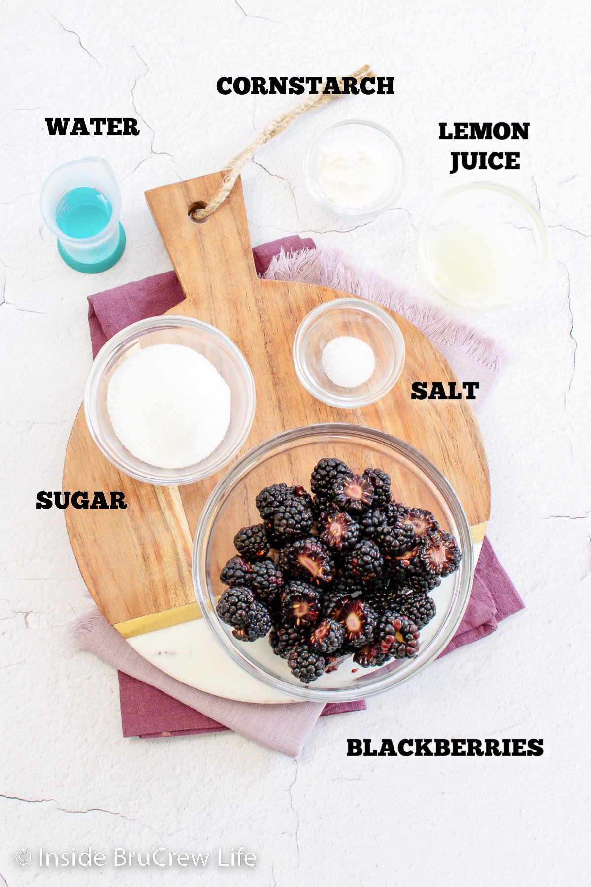 Bowls of ingredients needed to make a berry pie filling.