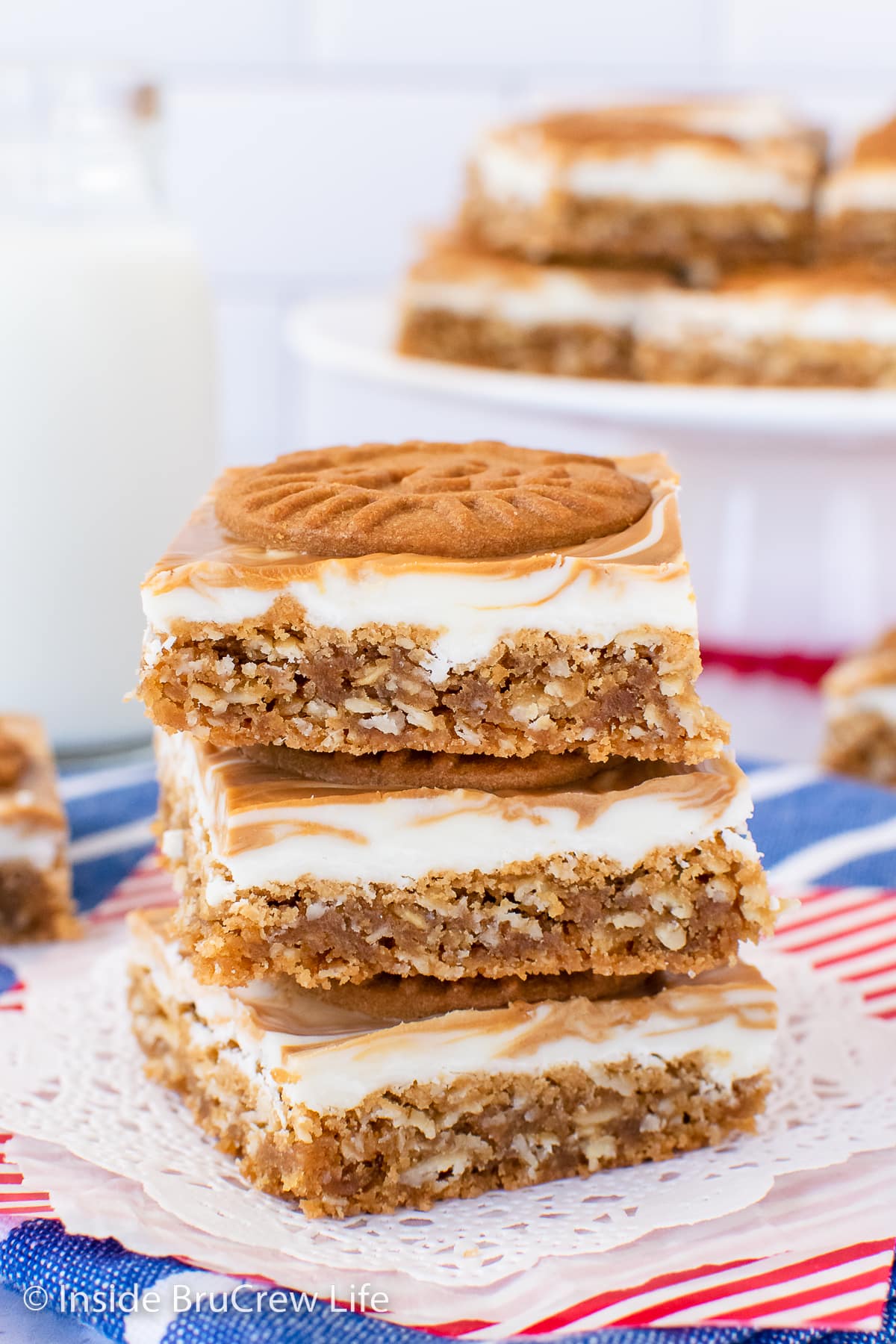 A stack of three oatmeal bars topped with white chocolate and cookies.