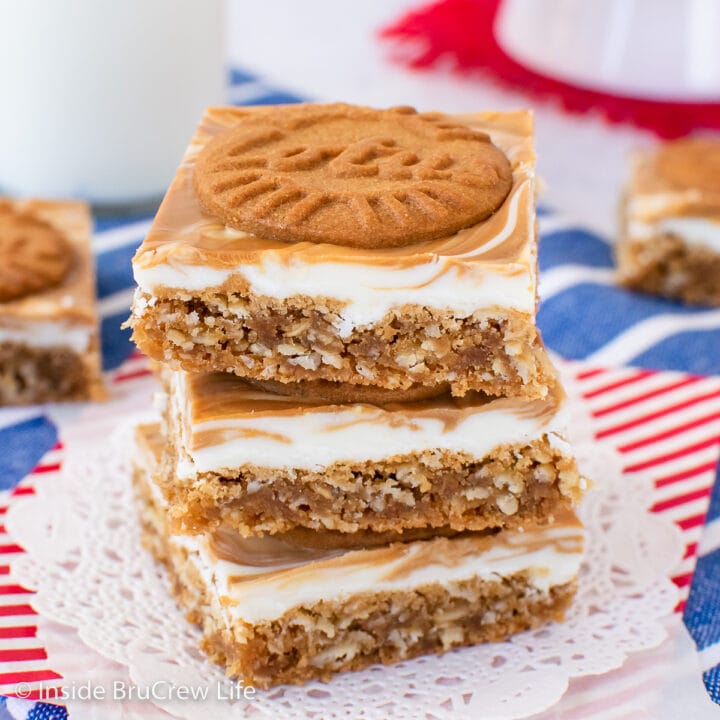 A stack of three oatmeal bars topped with white chocolate and cookies.
