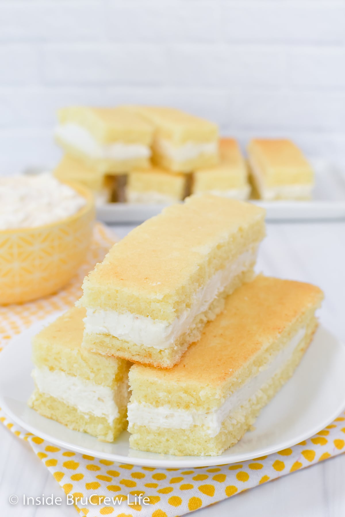 Three banana snack cakes on a white plate.