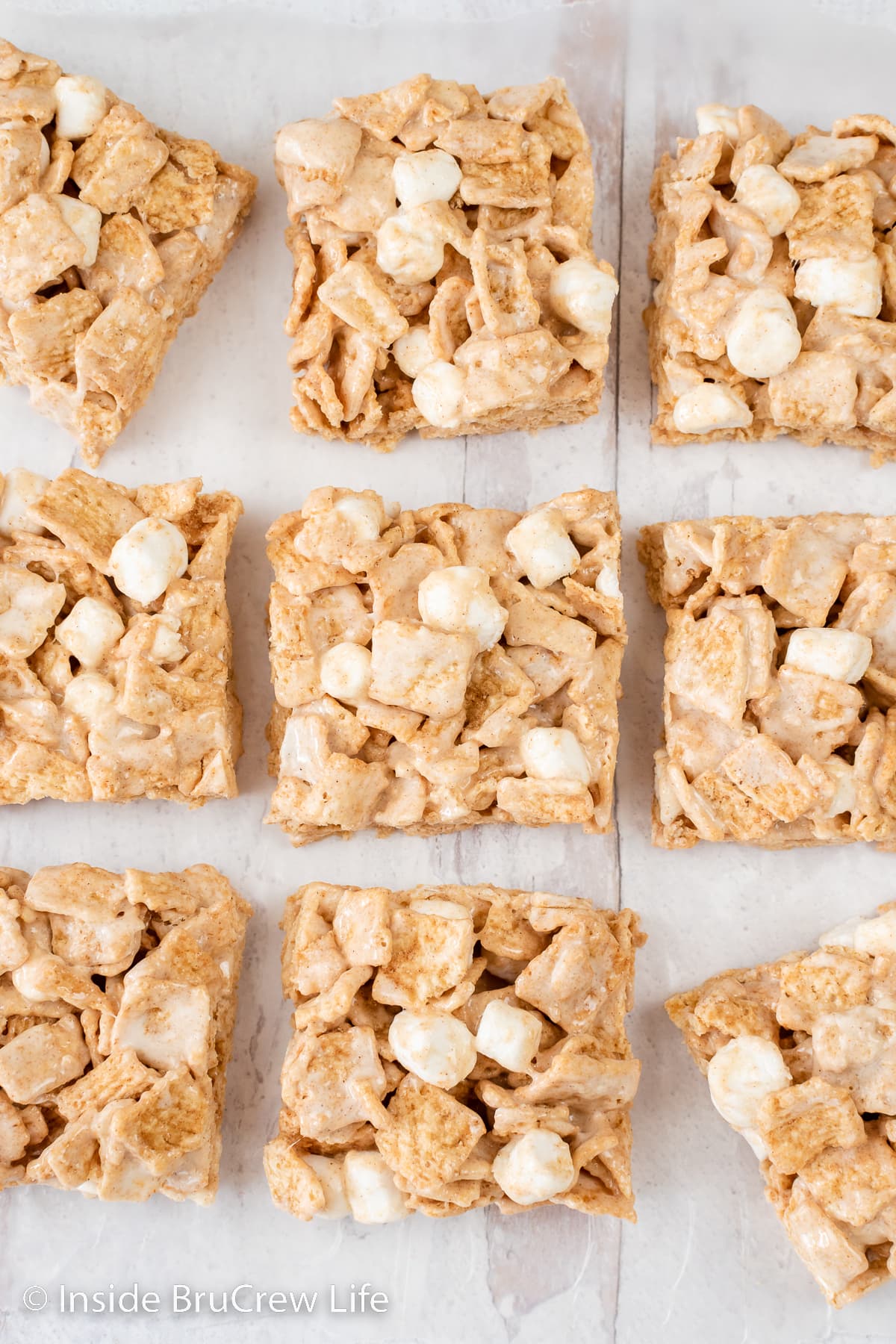 Cereal bars lined up on a white board.