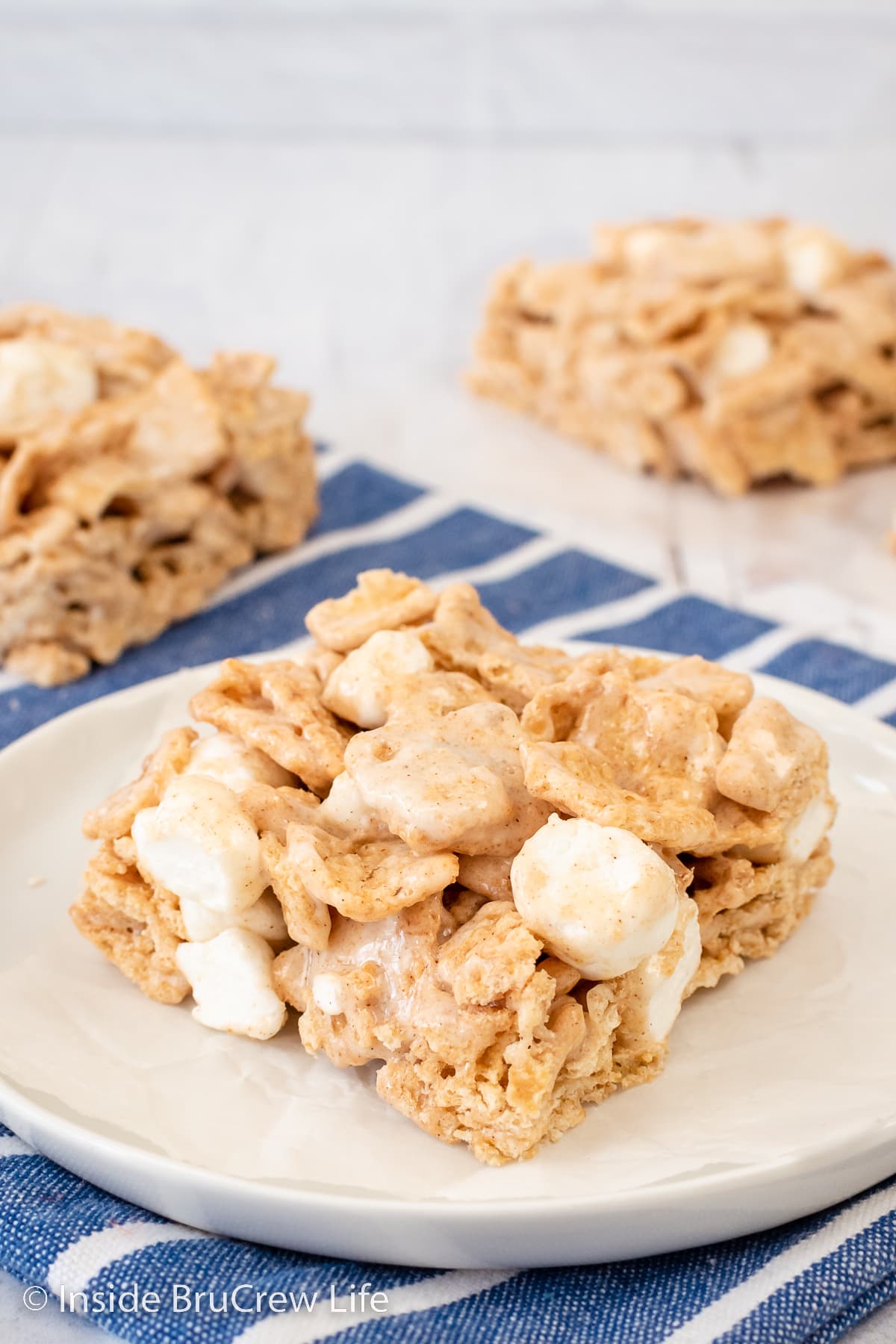 A cereal treat square on a white plate.