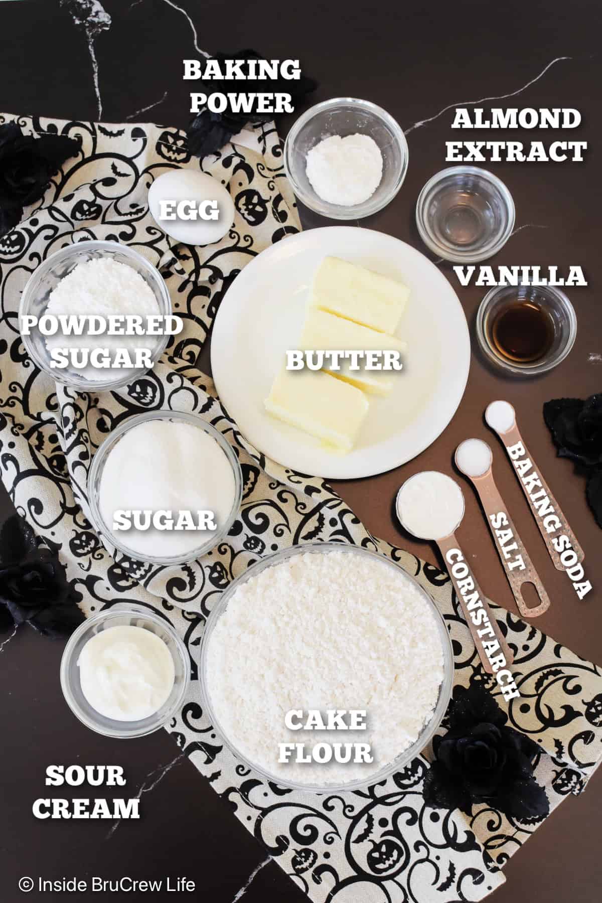 Ingredients needed to make sugar cookies for Halloween with labels.
