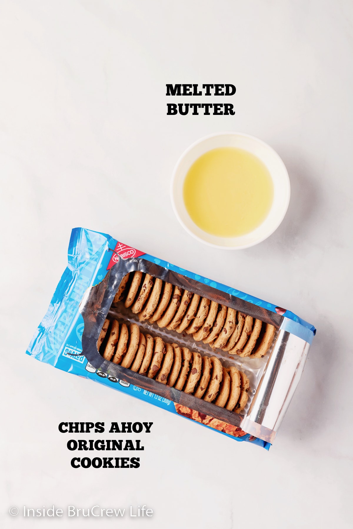 A white board with chocolate chip cookies and melted butter on it.