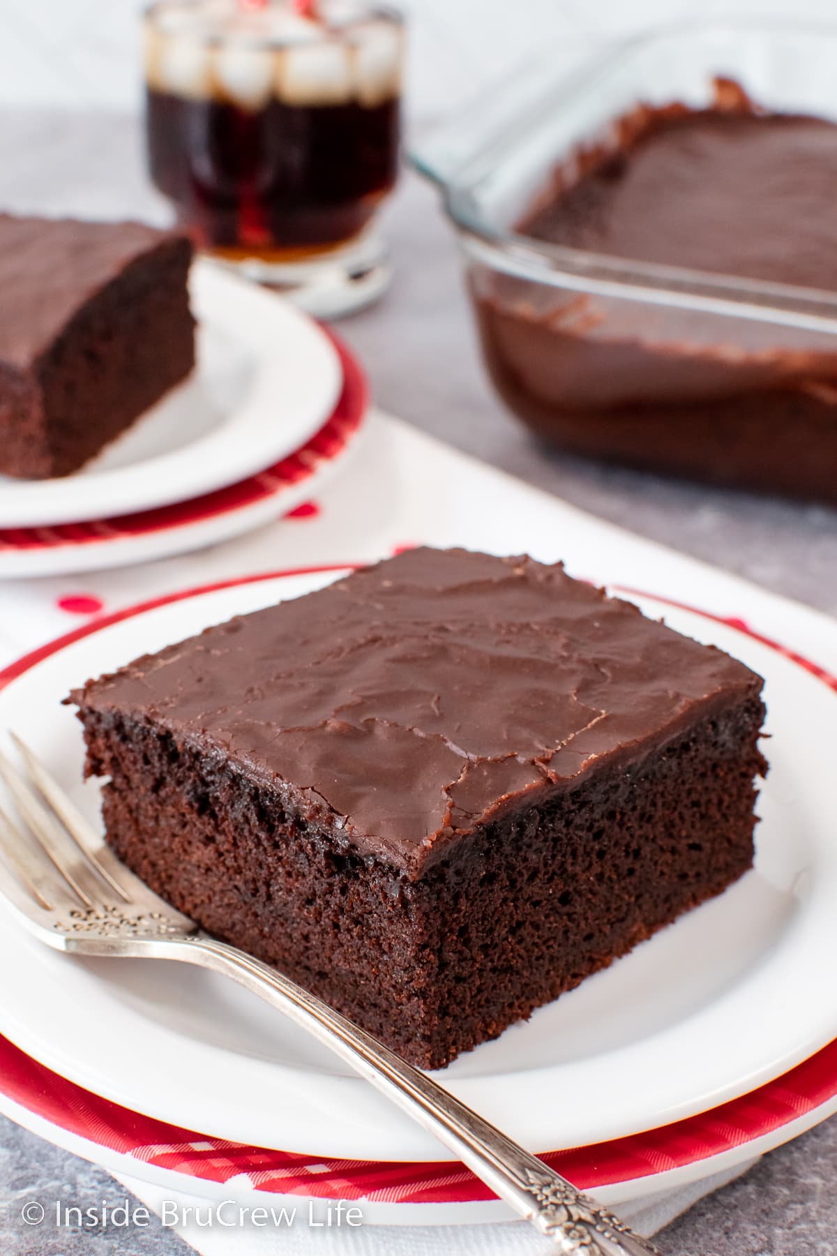 Squares of homemade chocolate cake on plates.