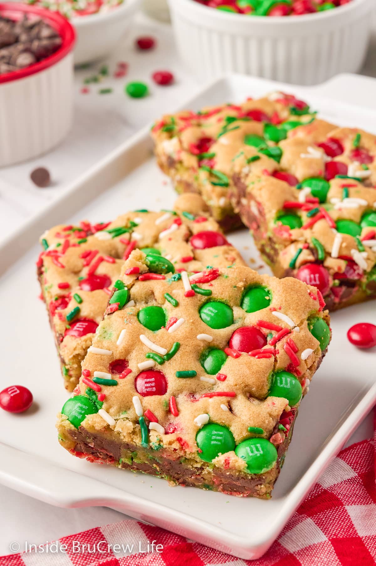 Holiday blonde brownies on a white tray.