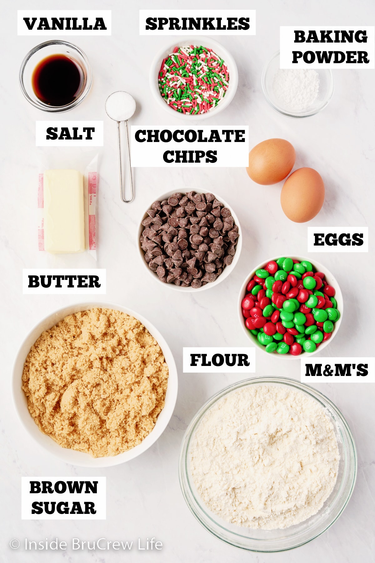 A white board with bowls of ingredients for M&M blondies.