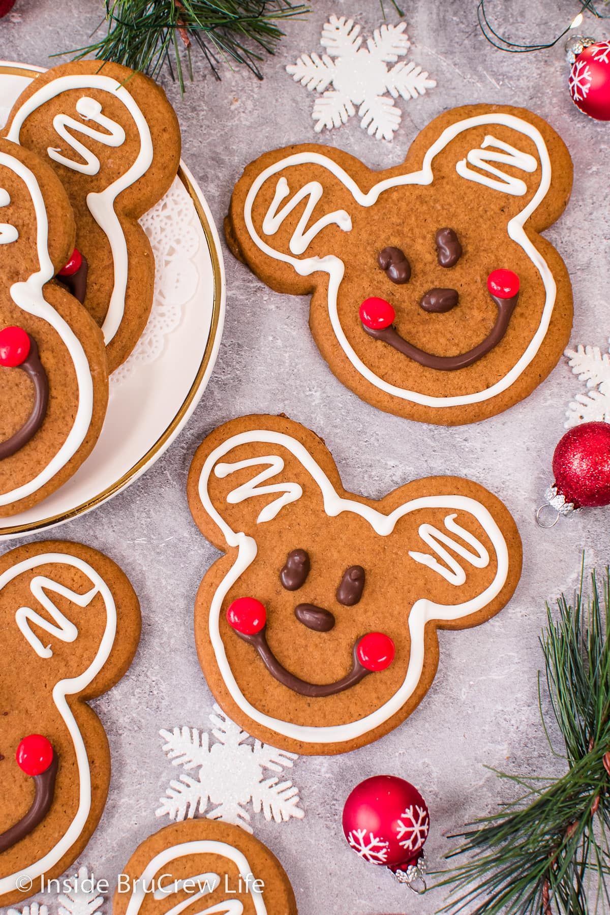 Decorated Mickey Mouse gingerbread cookies on a gray board.