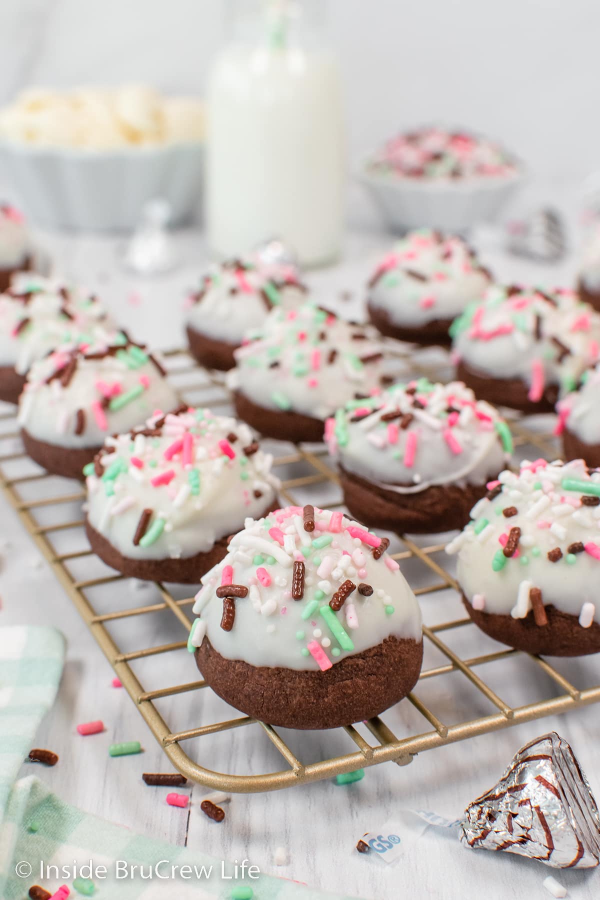 Chocolate bon bon cookies with white chocolate and sprinkles on top.