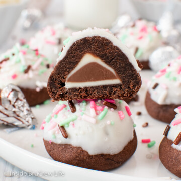 Two chocolate bon bon cookies stacked on a plate.
